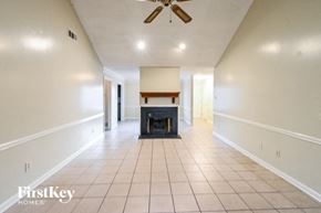 Memphis house for rent - an empty living room with a fireplace and white walls