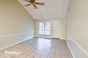 Memphis house for rent - an empty living room with white walls and a ceiling fan