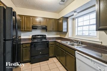 Memphis house for rent - a kitchen with black appliances and brown cabinets