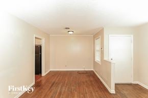 Memphis house for rent - a living room with a hard wood floor and white walls
