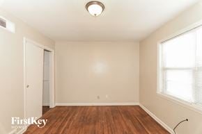 Memphis house for rent - a bedroom with wood flooring and a door to a closet