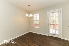 Douglasville house for rent - a living room with wood flooring and a door to a balcony