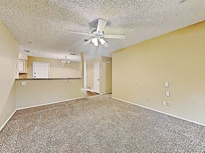 Fort Worth house for rent - an empty living room with a ceiling fan