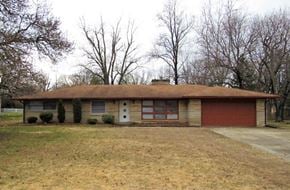 Indianapolis house for rent - A house with a red garage door and a brown roof.