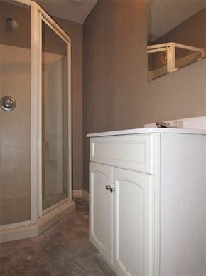 Indianapolis house for rent - A white bathroom cabinet with a glass door.