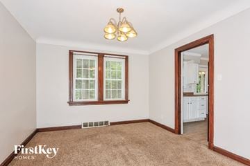 Florissant house for rent - a living room with a carpet and a door to a bathroom