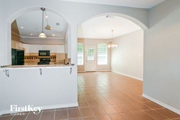 Spring house for rent - A kitchen with a white counter and a black fridge.