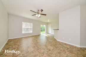 North Port house for rent - the spacious living room with tile flooring and a ceiling fan