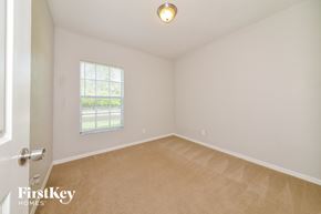 North Port house for rent - a bedroom with white walls and carpet and a window