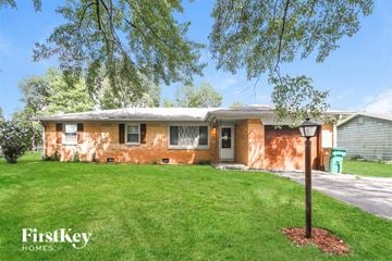 Brownsburg house for rent - a small brick house with a lawn and a lamp post