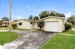 Lauderhill house for rent - A house with a white garage door and a driveway.