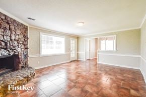 Memphis house for rent - A room with a stone fireplace and tile flooring.