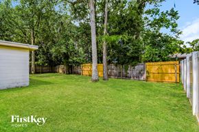 Jacksonville house for rent - a fisheye view of a backyard with a fence and trees