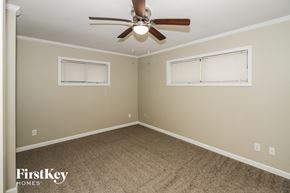 Memphis house for rent - a bedroom with a ceiling fan and a window