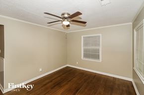Memphis house for rent - the living room of a home with a ceiling fan and wood floors