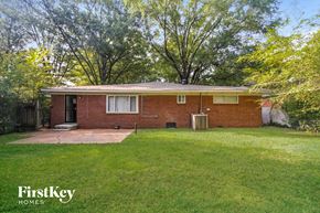 Memphis house for rent - the front of a brick house with a yard and grass