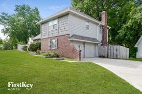 Kansas City house for rent - A house with a brick chimney and a garage is for sale.