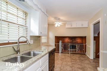 Kansas City house for rent - A kitchen with a sink and a window with blinds.