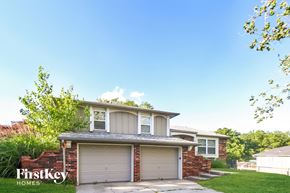 Blue Springs house for rent - a house with two garage doors and a sidewalk in front of it