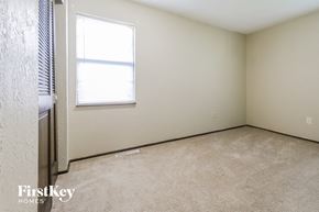 Blue Springs house for rent - a bedroom with a window and a carpeted floor
