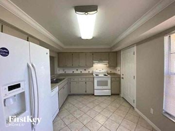Cape Coral house for rent - A kitchen with white appliances and cabinets.