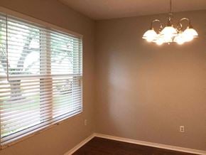Lakeland house for rent - a dining room with a large window and a chandelier