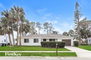 North Port house for rent - A house with a white garage door is for sale.