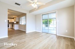 North Port house for rent - A spacious room with wooden flooring and a ceiling fan.