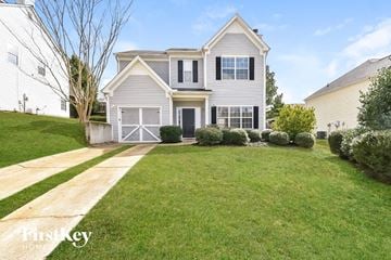 Union City house for rent - a white house with a lawn and a sidewalk in front of it