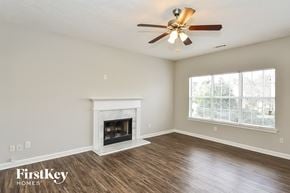 Union City house for rent - a living room with a fireplace and a ceiling fan
