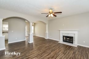 Union City house for rent - a living room with a fireplace and a ceiling fan
