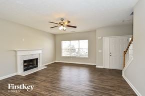 Union City house for rent - a living room with a fireplace and a ceiling fan