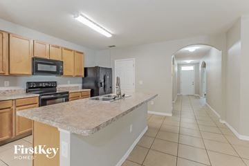 North Port house for rent - a kitchen with a granite counter top and a sink