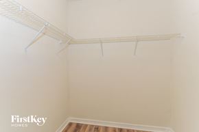 North Port house for rent - the closet of a bedroom with white walls and a white rack on the wall