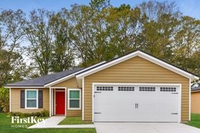 Jacksonville house for rent - a small yellow house with a white garage door