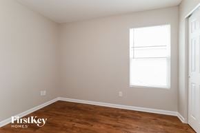 Jacksonville house for rent - a bedroom with a wood floor and a window