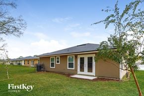 Jacksonville house for rent - a row of houses with a grassy yard and trees