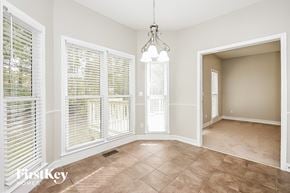 Acworth house for rent - a dining room with large windows and a chandelier