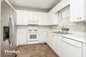 Acworth house for rent - a white kitchen with white cabinets and white appliances