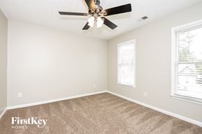 Acworth house for rent - a bedroom with carpet and a ceiling fan