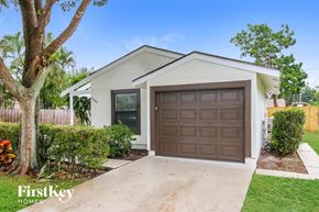 West Palm Beach house for rent - A house with a brown garage door is for sale.