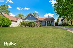 Memphis house for rent - A house with a blue roof and a white fence is for sale.