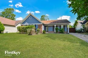 Memphis house for rent - A house with a blue roof and a white fence is for sale.