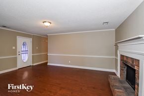 Memphis house for rent - A room with a fireplace and a door with a window.