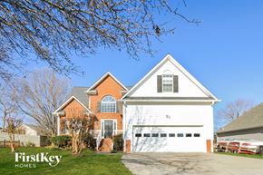 Pfafftown house for rent - a house with a white garage door and a blue sky