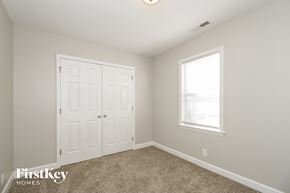 Pfafftown house for rent - a bedroom with a closet and a window and a white door