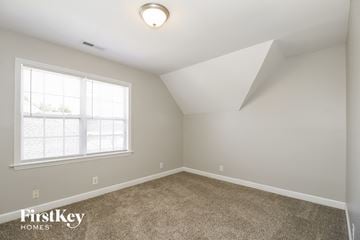 Pfafftown house for rent - the living room of a home with carpet and a window