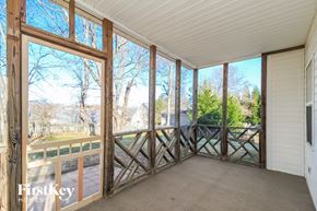 Pfafftown house for rent - a screened porch with a view of the yard and trees