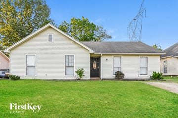 Memphis house for rent - a white house with a lawn in front of it