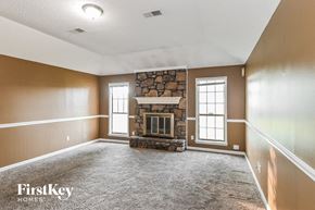Memphis house for rent - an empty living room with a stone fireplace